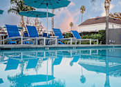 Thumbnail 39 of 44 - A pool with blue lounge chairs and umbrellas. at Nola 624, California, 91790