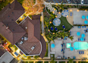Thumbnail 42 of 44 - A bird's eye view of a residential area with houses, a pool, and a playground. at Nola 624, West Covina, 91790