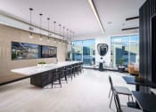 Thumbnail 9 of 24 - a dining room with a long table and chairs and a large window at NoMa Apartments, Walnut Creek, CA