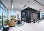 Thumbnail 8 of 24 - a living room with a fireplace and a table and chairs at NoMa Apartments, Walnut Creek