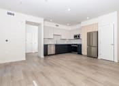 Thumbnail 13 of 52 - A kitchen with white cabinets and a black countertop.