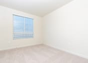 Thumbnail 19 of 52 - A room with a window covered by blinds.