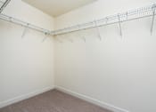 Thumbnail 20 of 52 - Empty room with a white wall and a metal rack on the wall.