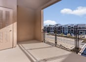 Thumbnail 22 of 52 - A balcony with a view of a residential area.