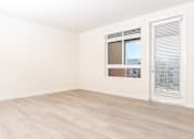 Thumbnail 26 of 52 - A room with a window and a sliding door.