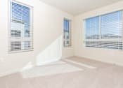 Thumbnail 39 of 52 - A room with two windows and a white floor mat.