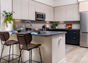 Thumbnail 38 of 93 - A Kitchen With Black Countertop at North Grove, Riverside, CA
