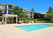 Thumbnail 25 of 39 - A swimming pool in a residential area with a building in the background at Avalon at Seven Hills Apartments, Nevada, 91790
