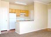 Thumbnail 12 of 39 - A kitchen with white appliances and wooden cabinets at Avalon at Seven Hills Apartments, Henderson, 91790