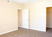 Thumbnail 13 of 39 - A room with a white door and carpeted floor at Avalon at Seven Hills Apartments, Henderson, NV, 91790