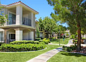 Thumbnail 35 of 39 - A building with a balcony and a green lawn in front at Avalon at Seven Hills Apartments, Nevada