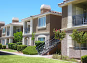 Thumbnail 33 of 39 - A row of houses with a clear blue sky above them at Avalon at Seven Hills Apartments, Henderson