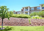 Thumbnail 38 of 39 - A large building with a green lawn in front at Avalon at Seven Hills Apartments, Henderson, NV, 91790