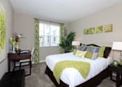 Thumbnail 32 of 123 - a bedroom with a large bed and a desk and a window
