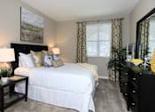 Thumbnail 28 of 123 - a bedroom with a bed and a dresser and a window