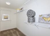 Thumbnail 30 of 123 - a closet with two shelves and a butterfly artwork on the wall