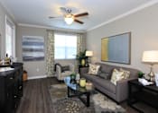 Thumbnail 31 of 123 - a living room with a ceiling fan and a couch
