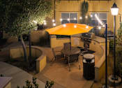 Thumbnail 93 of 112 - A patio with a table and chairs under an umbrella.