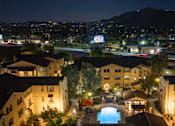 Thumbnail 102 of 112 - A pool in the middle of apartment buildings at night.