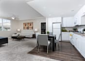 Thumbnail 10 of 112 - A modern kitchen with a dining table and chairs.