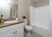 Thumbnail 19 of 112 - A white bathroom with a sink, toilet, and shower.