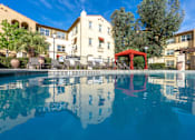 Thumbnail 4 of 112 - Red swing set is reflected in the water of a pool.