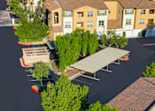 Thumbnail 101 of 123 - an aerial view of a parking lot with benches and trees