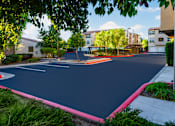 Thumbnail 83 of 123 - a basketball court in a neighborhood with buildings and trees