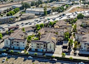 Thumbnail 85 of 123 - an aerial view of a neighborhood with cars on the street and houses