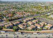 Thumbnail 86 of 123 - an aerial view of an intersection with cars and houses