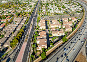 Thumbnail 89 of 123 - an aerial view of a suburb of a city with highways and cars