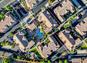 Thumbnail 91 of 123 - an aerial view of a suburban neighborhood with houses and cars