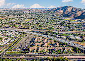 Thumbnail 92 of 123 - an aerial view of the city with highways and mountains