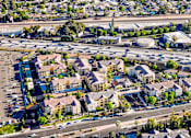 Thumbnail 93 of 123 - an aerial view of a suburb of a city with an intersection and parking lot