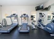 Thumbnail 8 of 123 - a row of treadmills and elliptical trainers in a gym