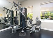 Thumbnail 9 of 123 - a gym with exercise equipment and a large window