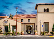 Thumbnail 61 of 123 - Leasing office with potted flowers and trees