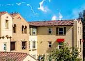 Thumbnail 63 of 123 - an apartment building with a red door and a blue sky