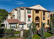 Thumbnail 59 of 123 - a group of apartment buildings with trees and a sidewalk