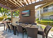 Thumbnail 24 of 57 - Outdoor dining area and TV adjacent to grill at Pointe Niguel, Laguna Niguel, California