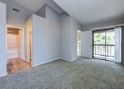 Thumbnail 29 of 57 - One Bedroom Apartments in Laguna Niguel CA - Pointe Niguel - Empty Bedroom with Carpeted Floor, Gray Walls, and Sliding Glass Door with Access to Balcony at Pointe Niguel, Laguna Niguel