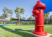 Thumbnail 40 of 57 - A red fire hydrant stands on a grassy field.