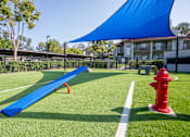 Thumbnail 41 of 57 - A blue shade structure is over a playground.