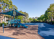 Thumbnail 44 of 57 - A playground with a blue slide and a green canopy.