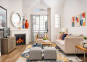 Thumbnail 17 of 59 - Living room with a large window and a wooden floor at The Preston Miracle Mile Apartments, Los Angeles, CA