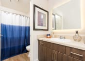 Thumbnail 23 of 59 - Bathroom with quartz countertops at The Preston Miracle Mile Apartments, California, 90036