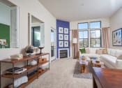 Thumbnail 13 of 84 - Living Room with Carpeted Floor, Area Rug, Sectional Couch, Coffee Table, Stand, Accent Wall, Fire Place, and Two Windows with Curtains at The Promenade Rio Vista, California
