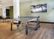 Thumbnail 23 of 84 - Apartments in Mission Valley for Rent - Community Ping-Pong Table with Nearby Seating and Natural Light. at The Promenade Rio Vista, San Diego, 92108