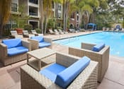 Thumbnail 51 of 84 - Resort-Style Pool with Wicker Patio Furniture, Lounge Chairs, Palm Trees, and Cabana at The Promenade Rio Vista, California, 92108