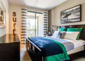 Thumbnail 57 of 84 - Bedroom with sliding glass doors to balcony at The Promenade Rio Vista, San Diego, CA